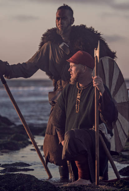istock Two sword wielding bloody medieval warriors together on a cold seashore 1009626878