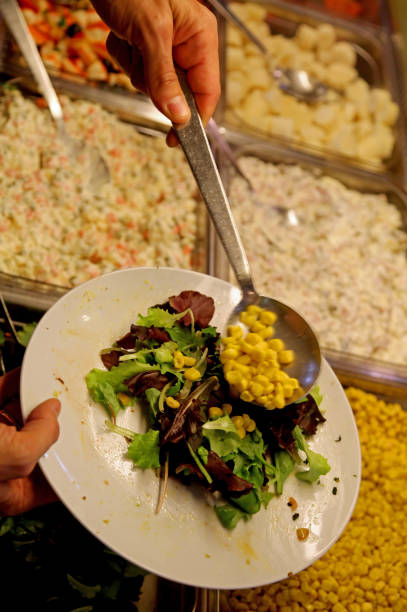 istock A restaurant customer serves himself putting lettuce and corn in 1009632180