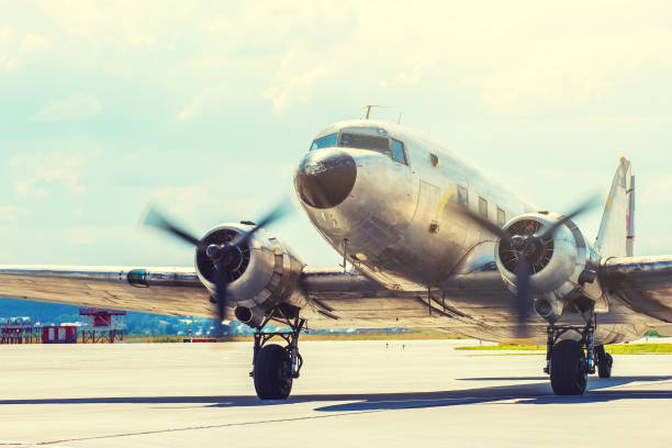 Old plane Douglas 40s taxiing after landing in the parking lot Old plane Douglas 40s taxiing after landing in the parking lot technology in the 1940s stock pictures, royalty-free photos & images