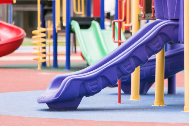 istock Children's playground with a slides on a street. 1009638338