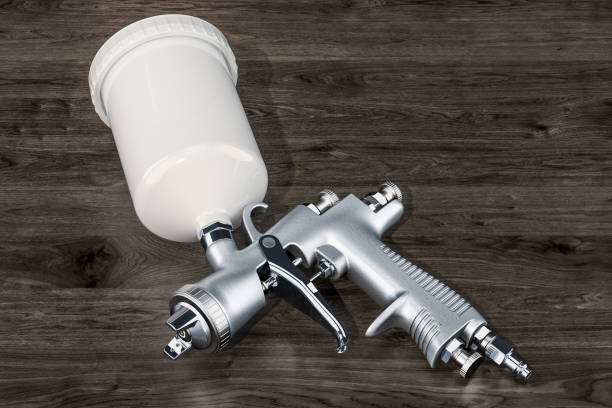 Carpenters tools. Air compressor with a nail gun and hard hat. Isolated on white.Please also see:
