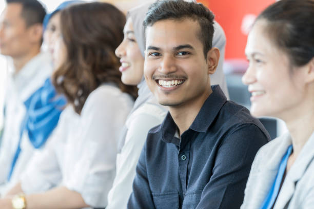 istock Young businessman smiles for camera during conference 1009647132