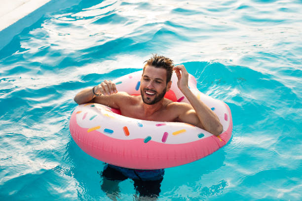 istock Young man in the swimming pool 1009651004