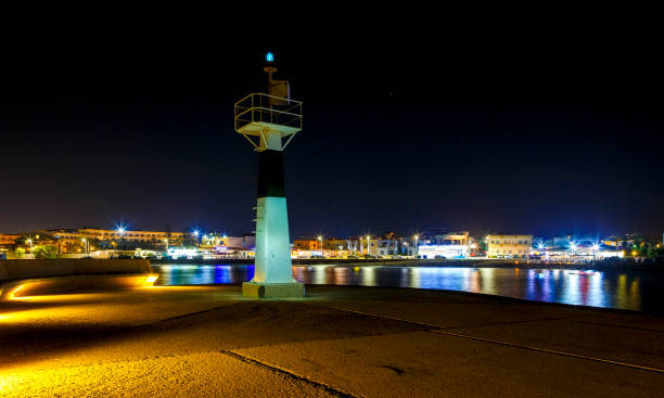 istock ighthouse on the pier, night, coastline, Crete, Greece, Gouves 1009651212