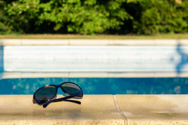 istock sunglasses and swimming pool 1009659312