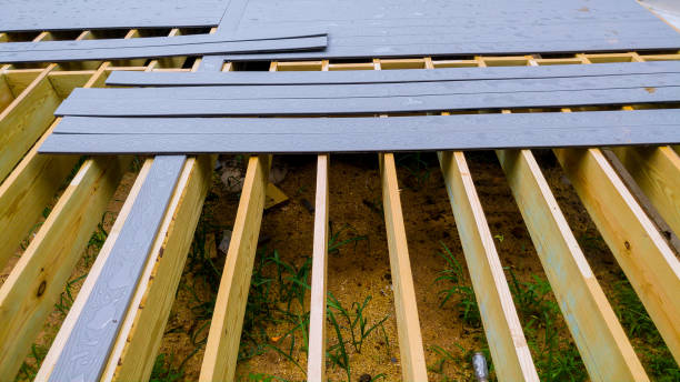 istock Repair and replacement of an old wooden deck or patio with modern composite plastic material 1009667382