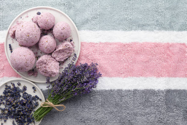 istock Handmade lavender bath bombs and flowers on towel 1009672222