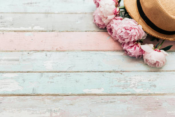 istock Pink peony with hat on vintage wooden background. Top view, copy space, flat lay 1009679556