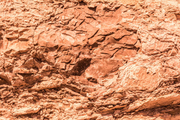 red relief texture of an old destroyed granite stone, geology abstract background