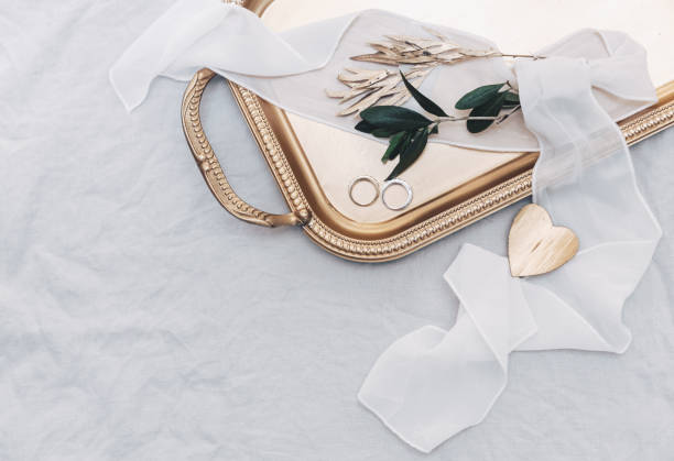 istock Wedding rings on gold tray with olive branch. Stylish wedding concept 1009680498
