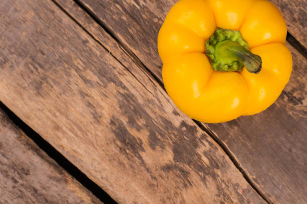 istock Juicy beautiful Bulgarian pepper on a wooden background. 1009683004