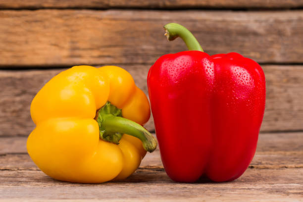istock Two bell peppers, yellow and red. 1009683074