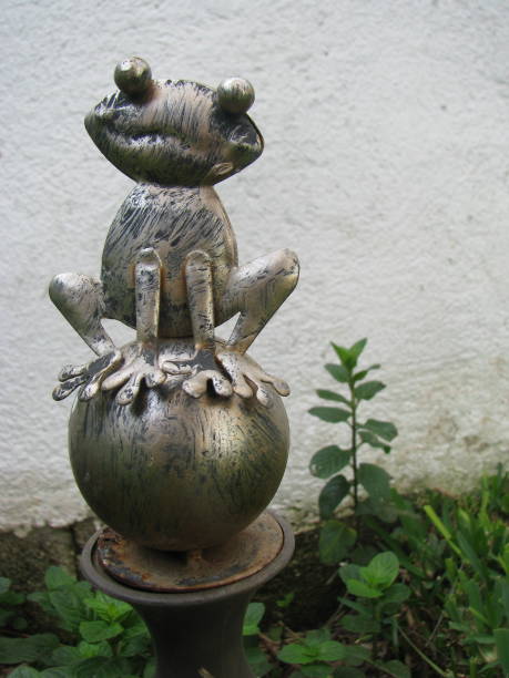 Rusty old garden decoration showing a frog on top
