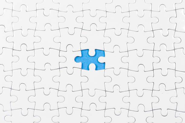 istock Blue background made from white puzzle pieces and place for your content 1009691496