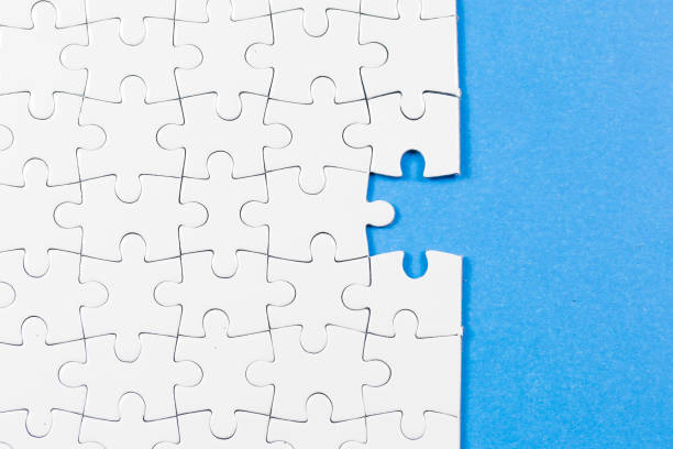 istock Blue background made from white puzzle pieces and place for your content 1009691508