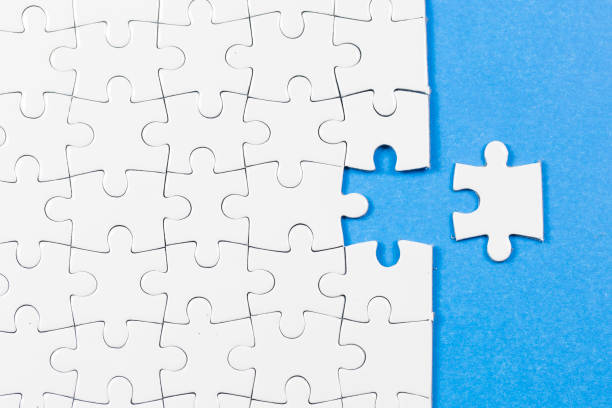 istock Blue background made from white puzzle pieces and place for your content 1009691512