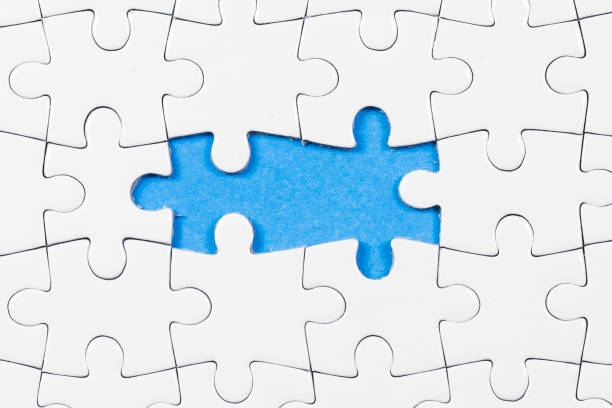 istock Blue background made from white puzzle pieces and place for your content 1009691524