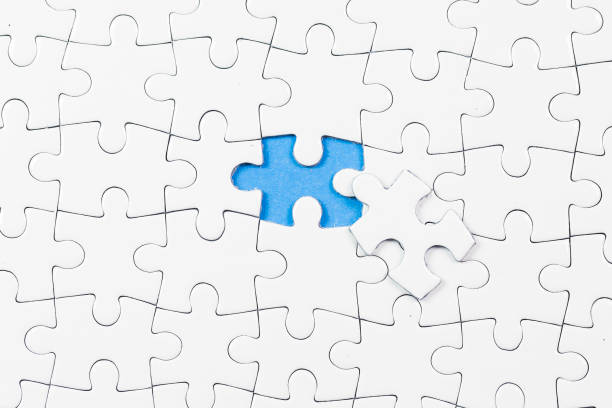 istock Blue background made from white puzzle pieces and place for your content 1009691528