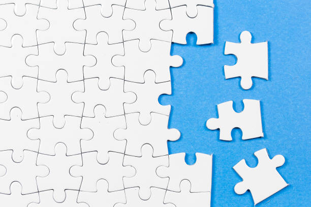 istock Blue background made from white puzzle pieces and place for your content 1009691534
