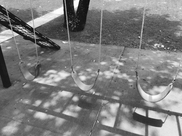 istock Deserted playground with dramatic shadows in Black and white 1009696848