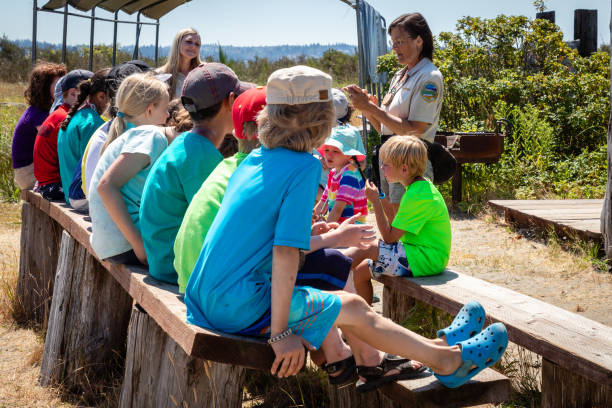 Teacher demonstrating to children how large different size whales are by using a rope during a nature class on Jetty Island Washington Everett Washington/USA 7/25/2018: Teacher demonstrating to children how large different size whales are by using a rope during a nature class on Jetty Island Washington everett washington state photos stock pictures, royalty-free photos & images