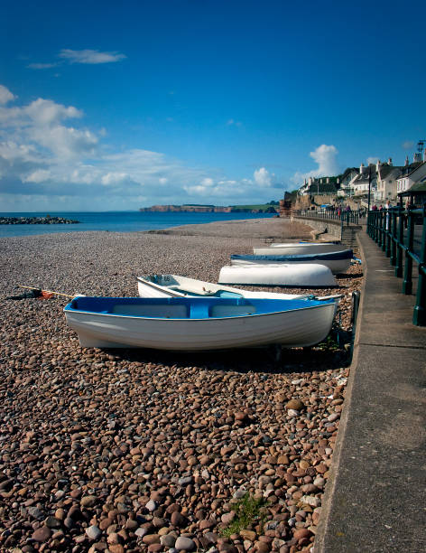istock Boats pulled up onto the shore at Sidmouth in Devon. 1009702850