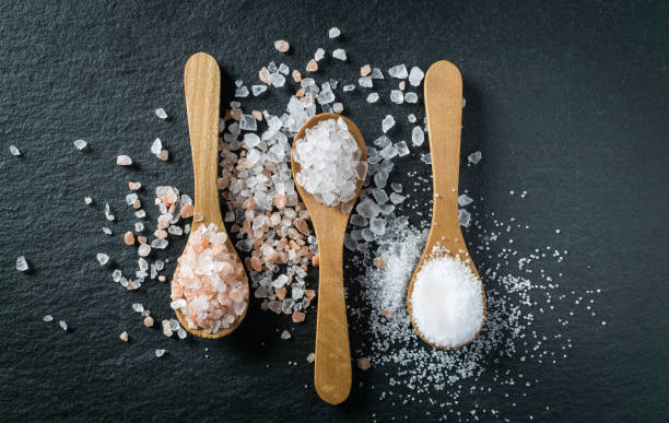 istock Different types of salt. Top view on three wooden spoons 1009708802