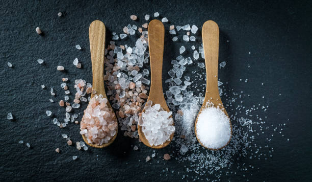 istock Different types of salt. Top view on three wooden spoons 1009708882