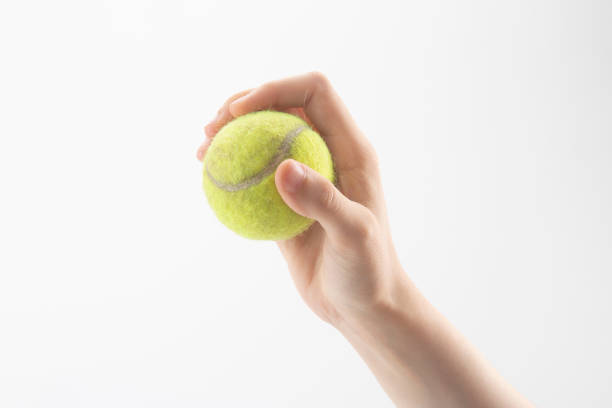 istock Tennis ball in hand isolated 1009716156