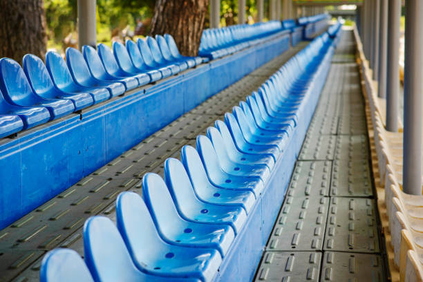 istock Empty plastic chairs in the stands of the stadium 1009738610
