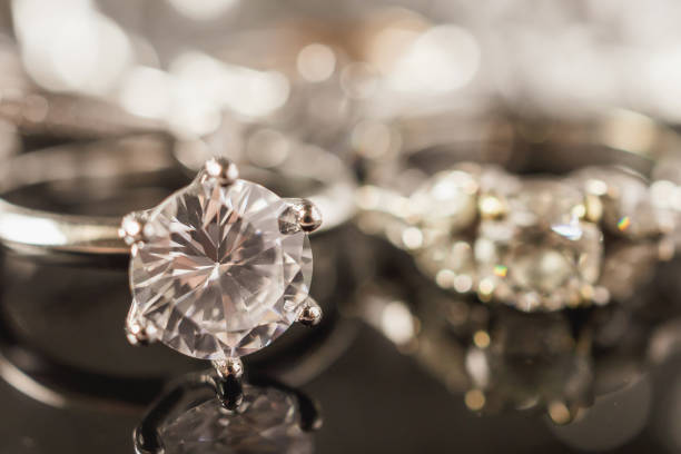 istock Luxury Jewelry diamond rings with reflection on black background 1009741808