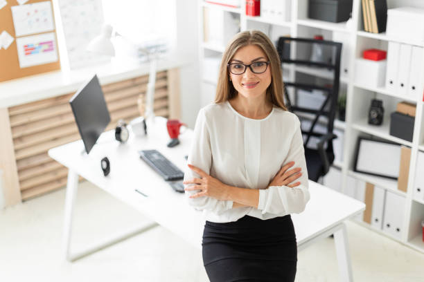 istock A young girl is standing leaning on a table in the office. 1009742098