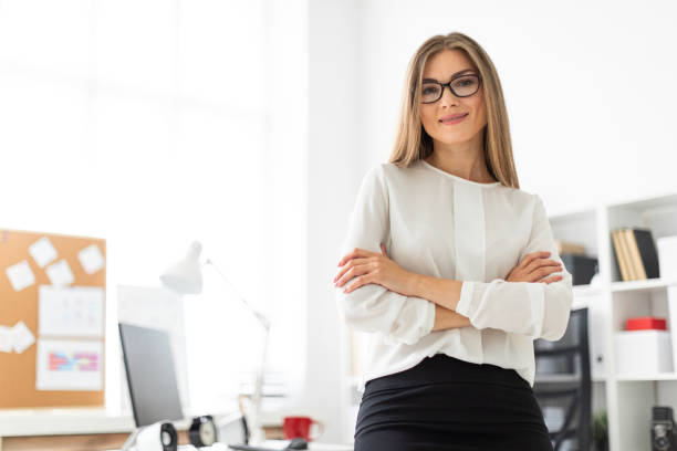 istock A young girl is standing leaning on a table in the office. 1009742106
