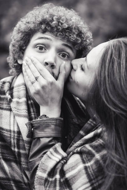 istock happy couple is hiding behind plaid autumn day. 1009742780