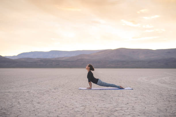Ethnic woman doing yoga in the desert