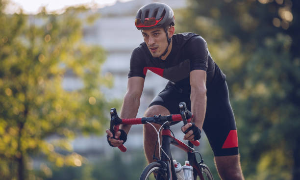 istock Man riding racing bicycle in park 1009749806