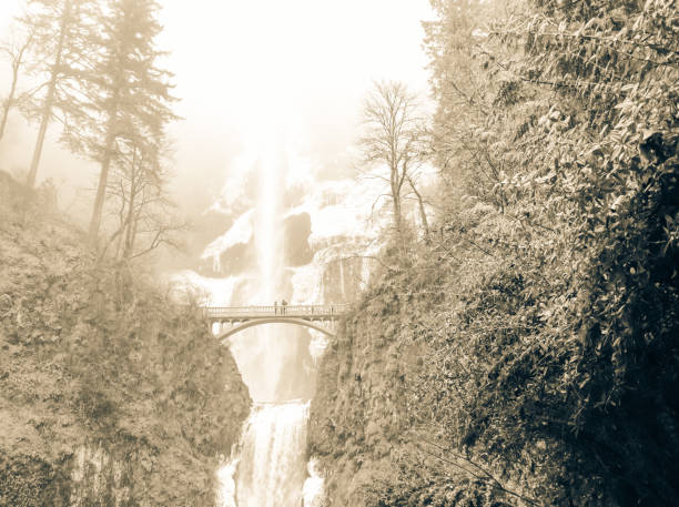 Vintage tone icy Multnomah Falls in winter time. It is a waterfall on the Oregon side of the Columbia River Gorge, along the Historic Columbia River Highway. Natural and seasonal waterfall background