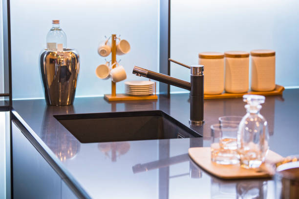 istock Water faucet in the modern kitchen. Concrete countertop and luxury kitchen. 1009764272