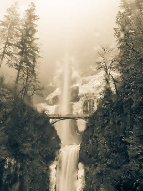 Vintage tone icy Multnomah Falls in winter time. It is a waterfall on the Oregon side of the Columbia River Gorge, along the Historic Columbia River Highway. Natural and seasonal waterfall background
