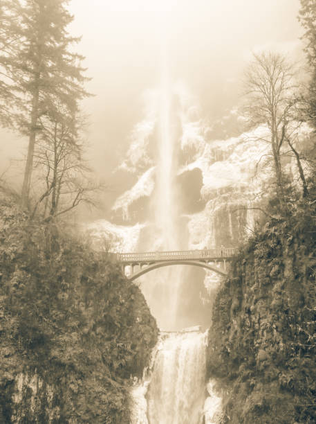 Vintage tone icy Multnomah Falls in winter time. It is a waterfall on the Oregon side of the Columbia River Gorge, along the Historic Columbia River Highway. Natural and seasonal waterfall background