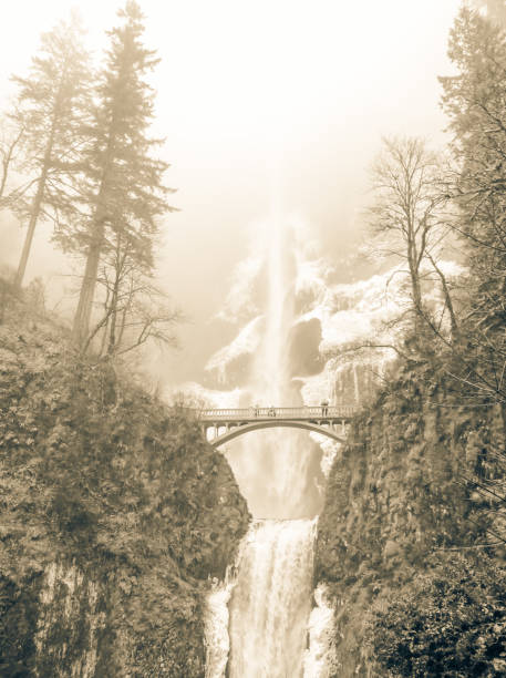 Vintage tone icy Multnomah Falls in winter time. It is a waterfall on the Oregon side of the Columbia River Gorge, along the Historic Columbia River Highway. Natural and seasonal waterfall background