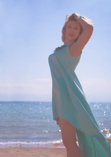 istock Female in blue dress on the coast side 1009785088