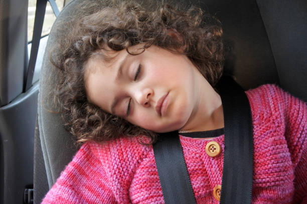 istock Small girl sleeping in a car seat 1009793174