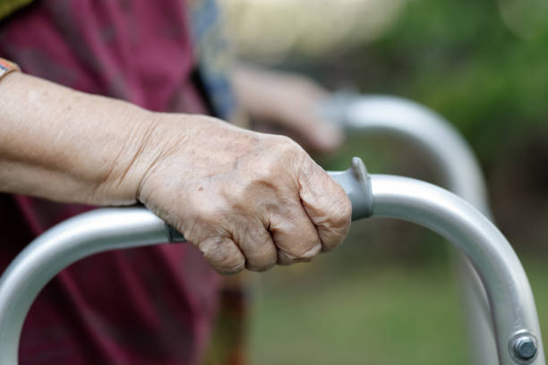 istock Elderly woman using a walker in backyard 1009796278