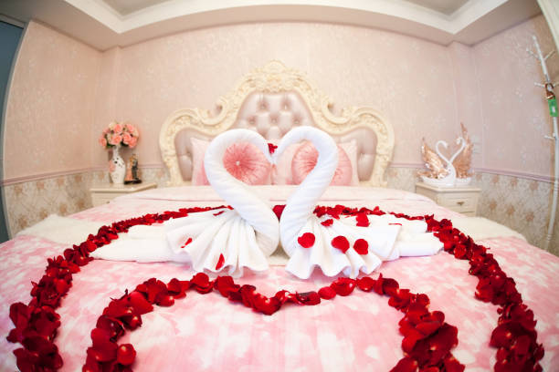 istock two towel swans shaped on the bed,Honey moon bed.Honeymoon 1009801124