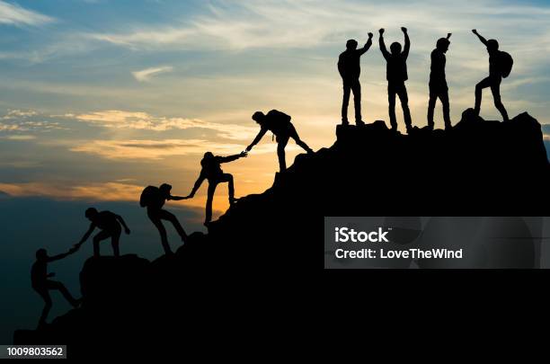 Group Of People On Peak Mountain Climbing Helping Team Work Travel Trekking Success Business Concept Stock Photo - Download Image Now