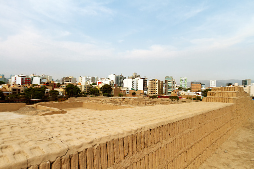 Partial view of the Huaca Pucllana ruins in Lima (Peru) with residential buildings in the background