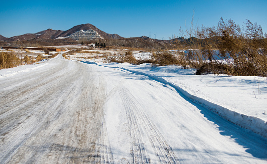 Empty dirt road in winter.