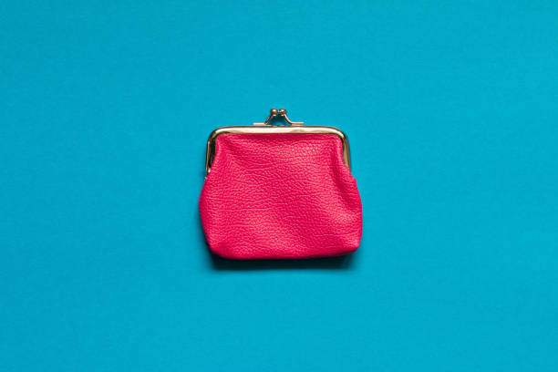 istock Pink wallet on blue background . Close up. Top view 1009822640