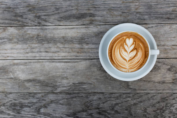 a cup of cappuccino with latte art - cappuccino latté coffee high angle view imagens e fotografias de stock